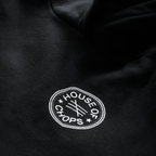 Detail shot of print quality on Cut 001 black hoodie showing fabric texture and design clarity.