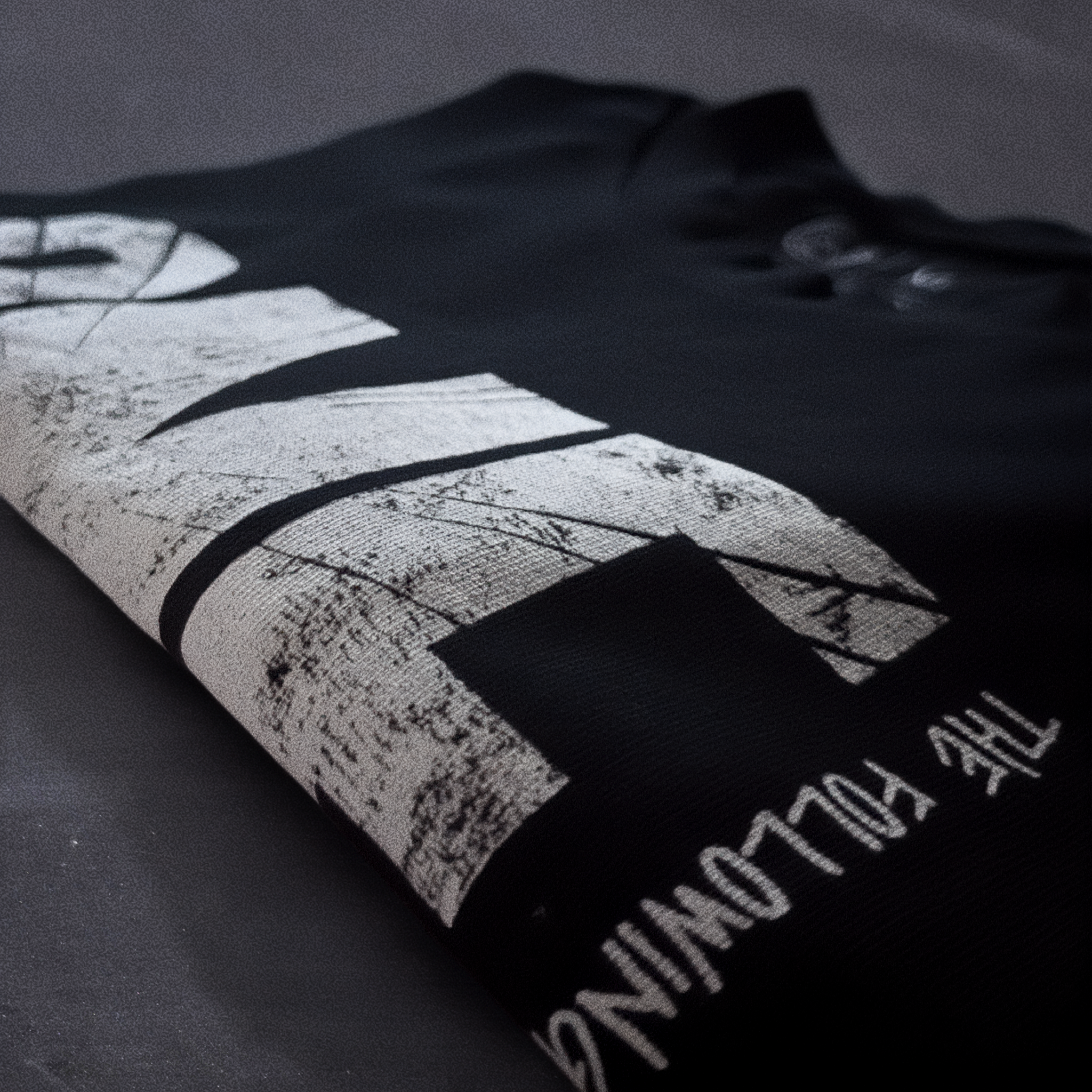 Detail shot of print quality on Cut 001 black t-shirt showing fabric texture and design clarity.