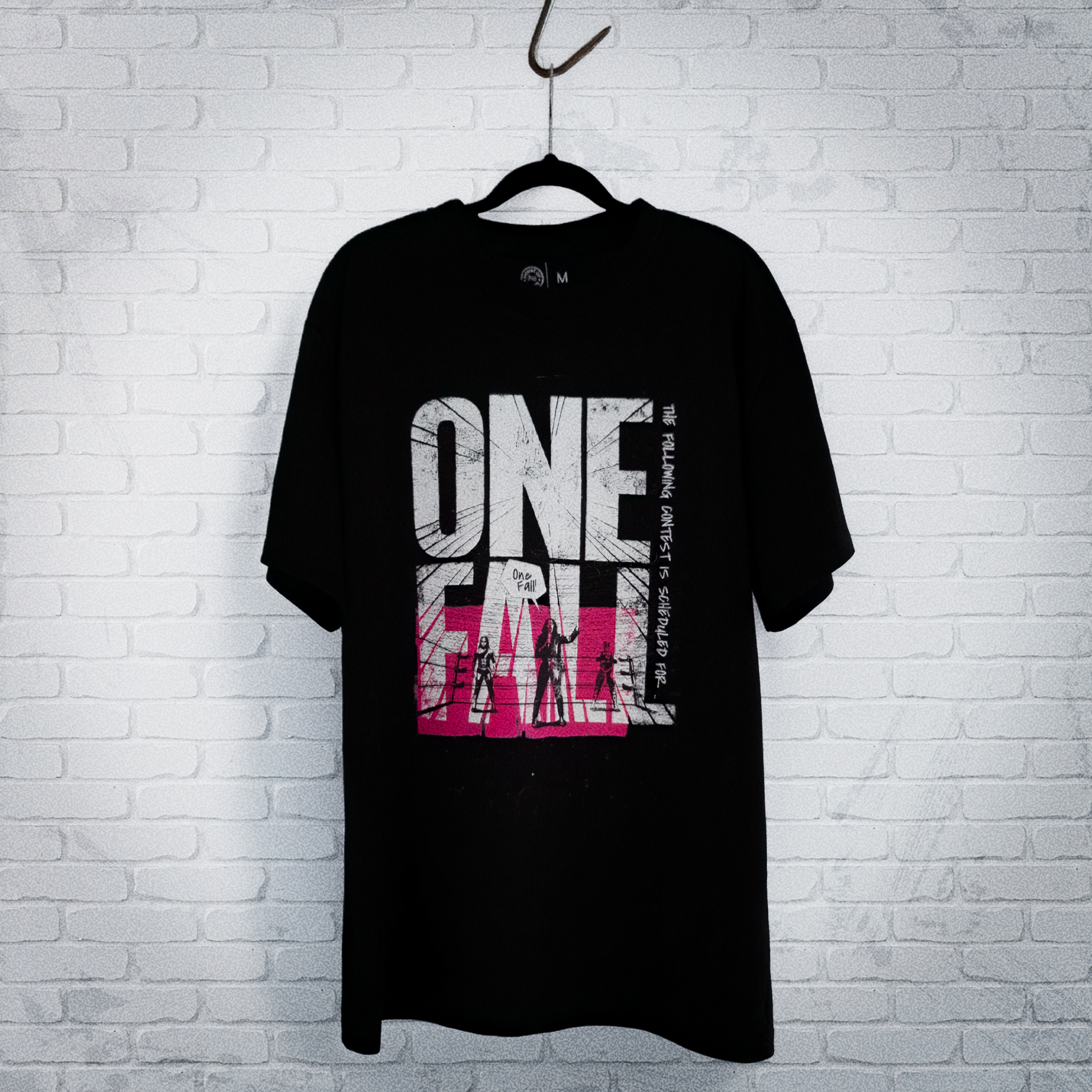 Cut 001 black t-shirt front displayed on hanger showing natural drape and heavyweight fabric construction - against a white wall.
